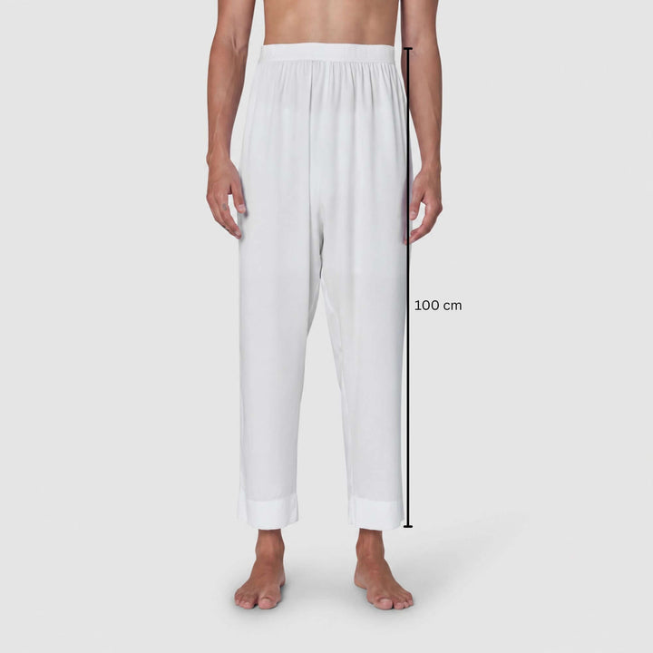 White relaxed-fit pants shown on a model from the waist down against a light gray background, with a vertical measurement marker indicating 100 cm length.